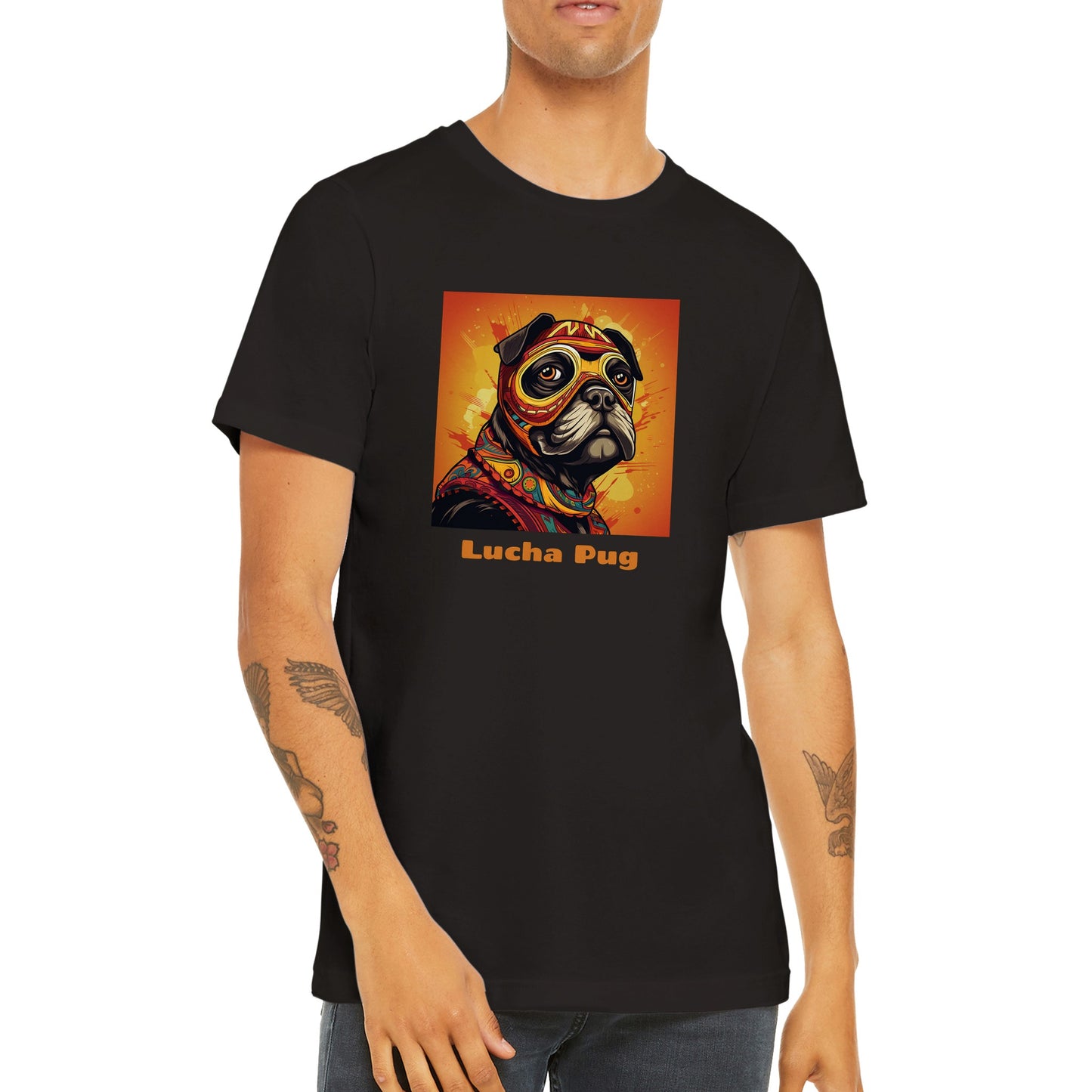 Torso of a young man wearing a black t-shirt with the head and shoulders of a black pug in a colorful lucha mask and outfit on an orange background with the words "Lucha Pug" under the image.
