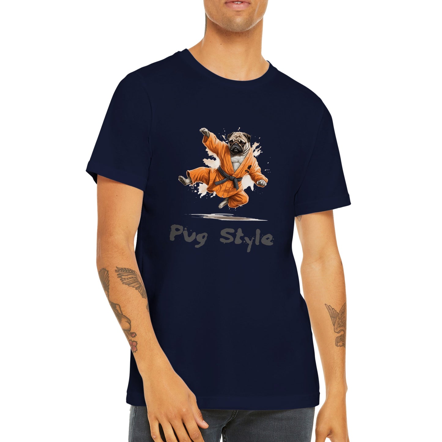 Torso of a young man with arm tattoos wearing a navy t-shirt with a picture of a cartoon pug wearing an orange gi and doing a flying sidekick with the words "Pug Style" written underneath.