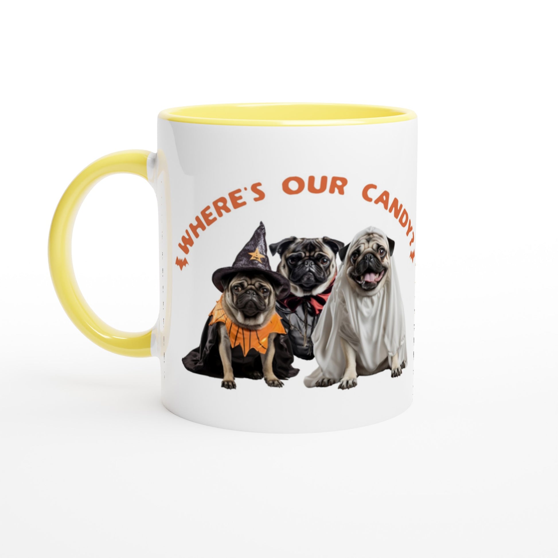 White mug with yellow handle, rim, and inside  with a picture of three pugs--one dressed as a witch, one dressed as a vampire, and one dressed as a ghost with the words "Where's our candy?" arched over them.