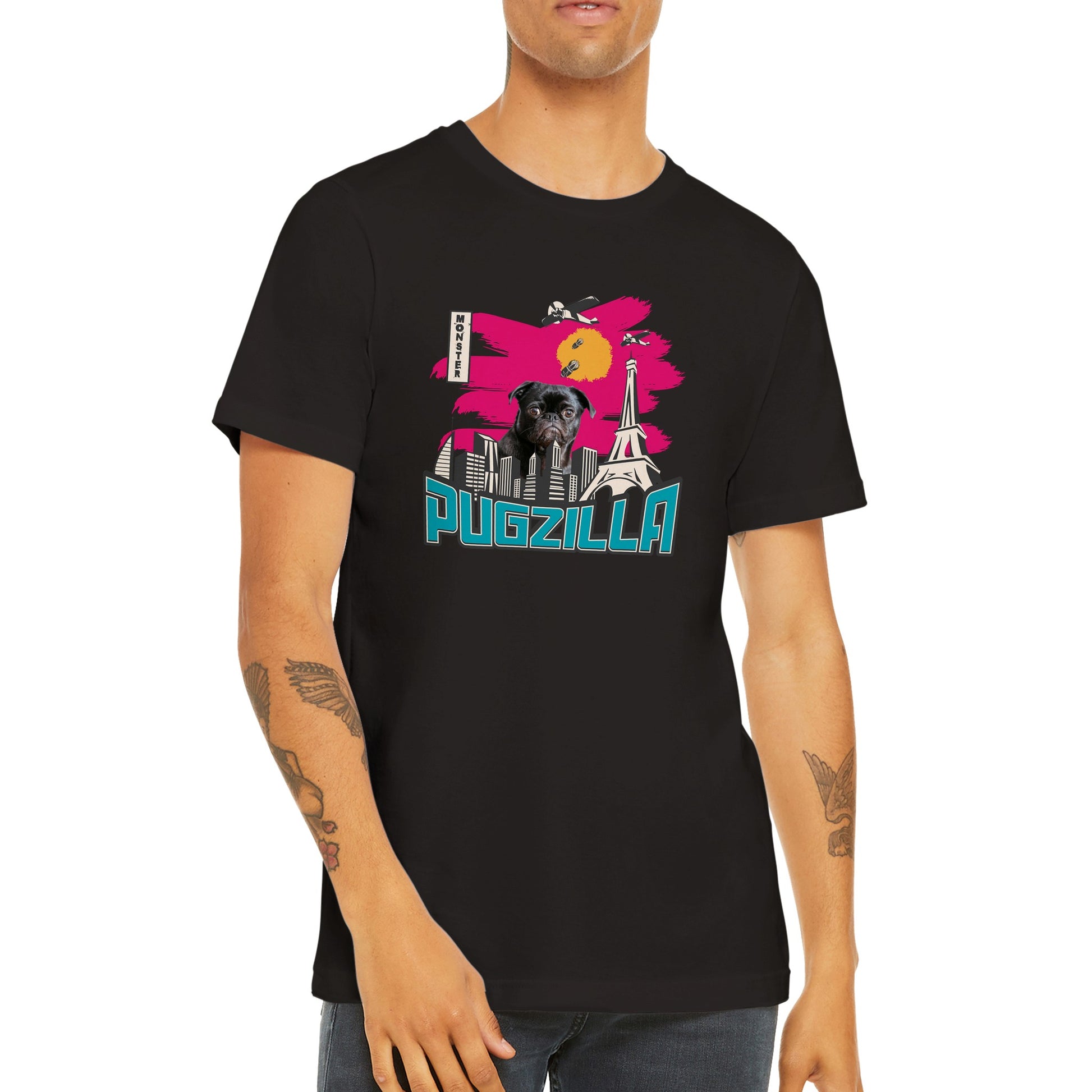 Torso of a young man wearing a black t-shirt with the image of a black pug standing over a cityscape under a pink sky with jets dropping bombs on him and with the word "Pugzilla" under it.