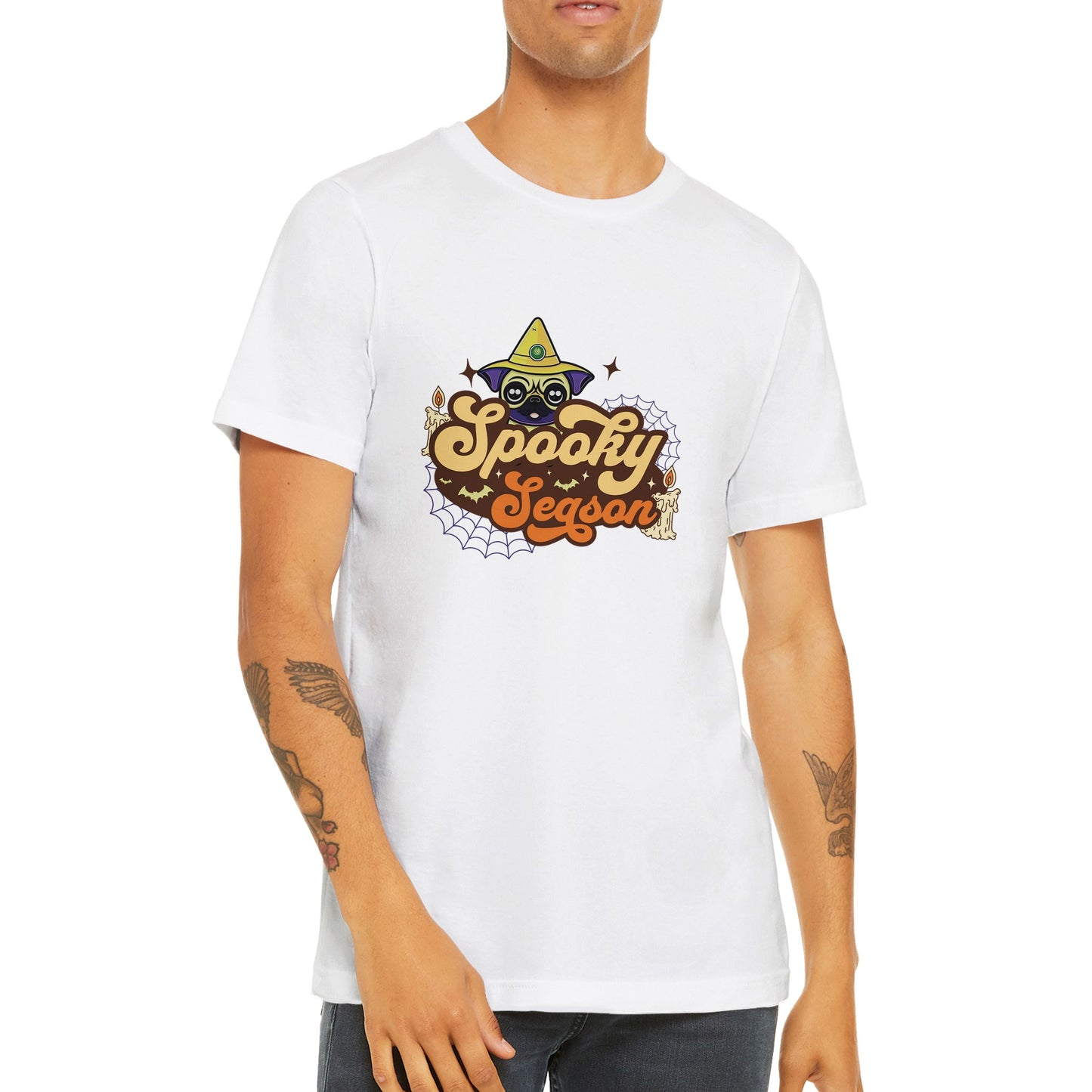 Torso of a young man wearing a white t-shirt with the image of a pug's head in a witch's hat and the words "Spooky Season" below it. The image also has cobwebs, bats, and candles in it.