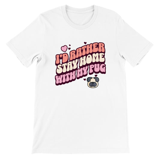 White t-shirt with the words "I'd rather stay home with my pug" in an orangey-pink, beige, and pink colored bubble-style lettering on it and small hearts above the words to the left and a small heart above the words to the right with two other small hearts  and a picture of a cartoon pug face below the words on the right.