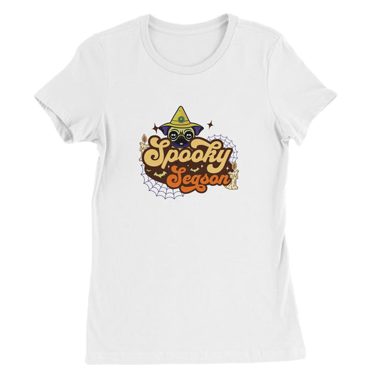 White t-shirt with the image of a pug's head in a witch's hat and the words "Spooky Season" below it. The image also has cobwebs, bats, and candles in it.