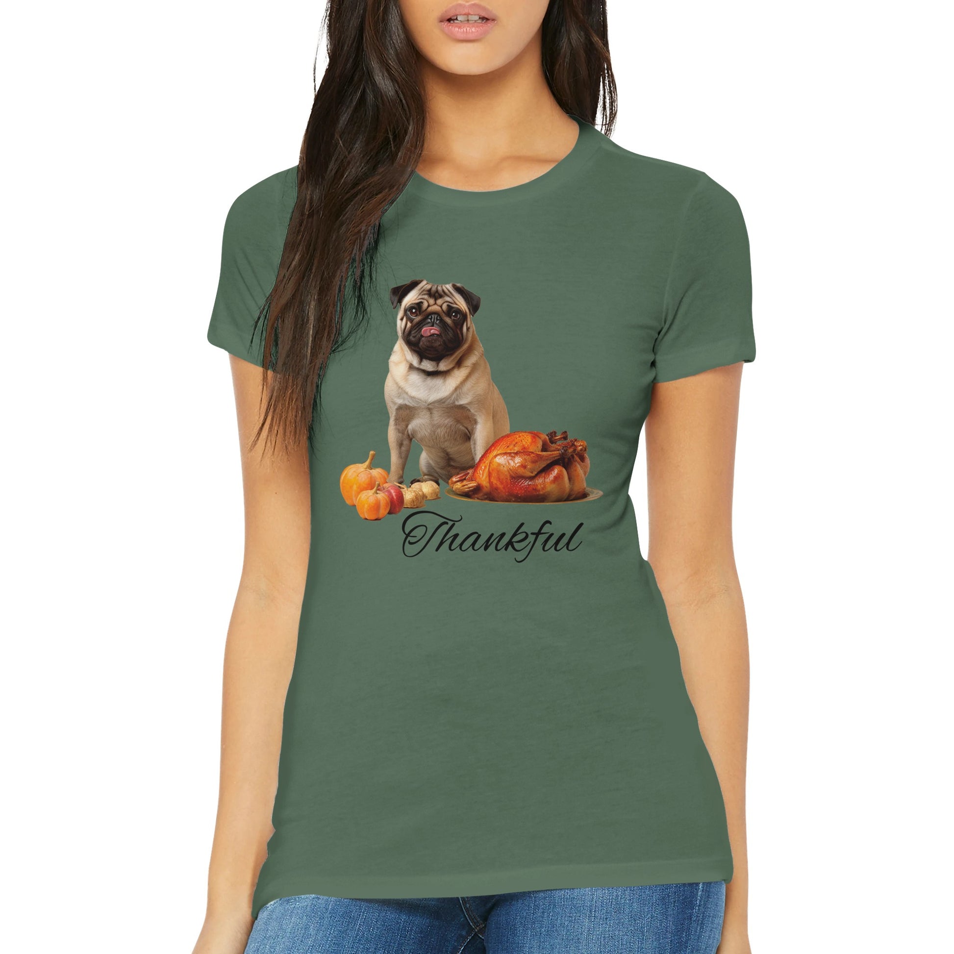 Torso of a woman wearing a military green women's t-shirt with a pug sitting behind pumpkins and a roast turkey with the word "Thankful" under it.