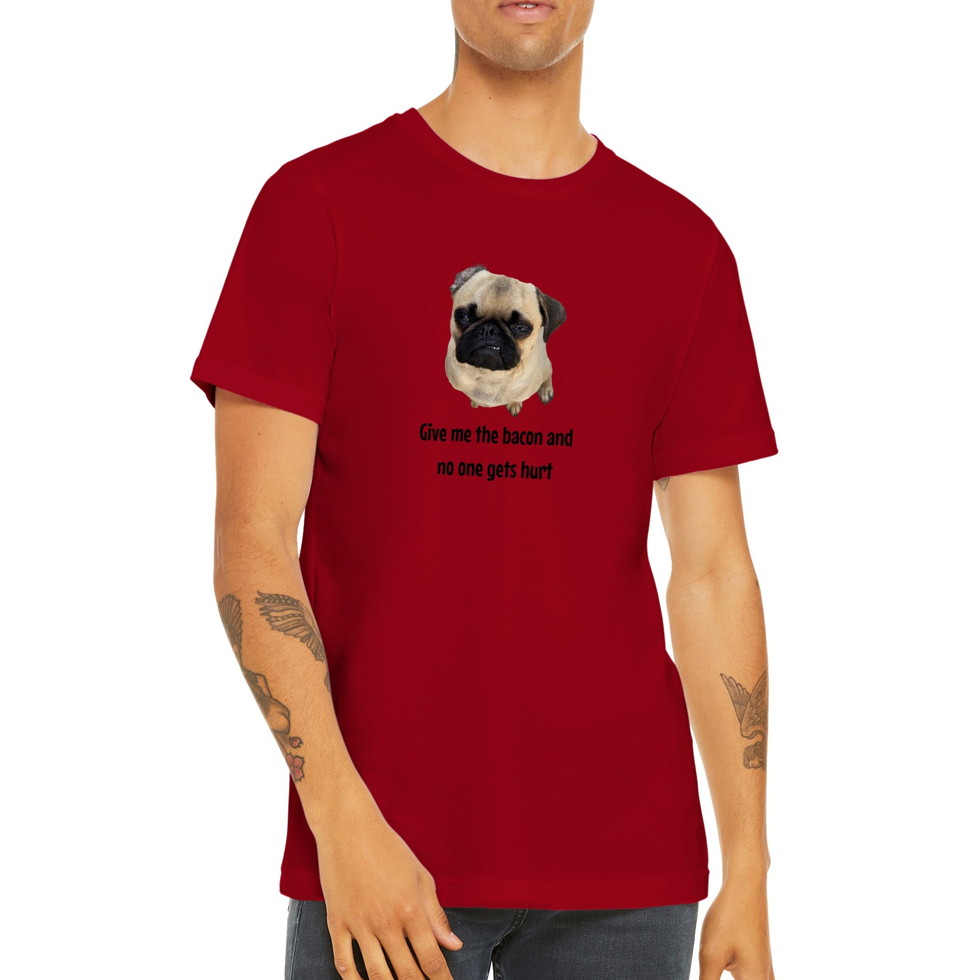 Torso of a young man wearing a red t-shirt with a picture of a fawn-colored pug doing a lip curl and the words "Give me the bacon and no one gets hurt" under it