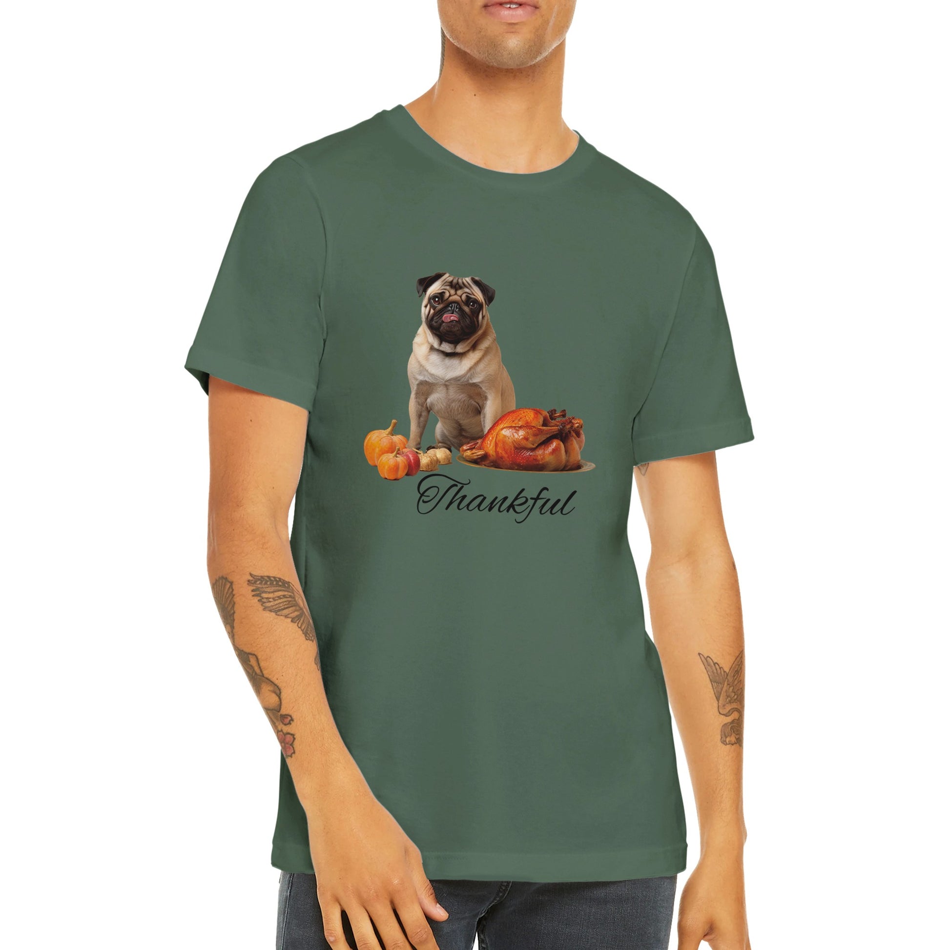 Torso of a man wearing a military green t-shirt with a pug sitting behind pumpkins and a roast turkey with the word "Thankful" under it.