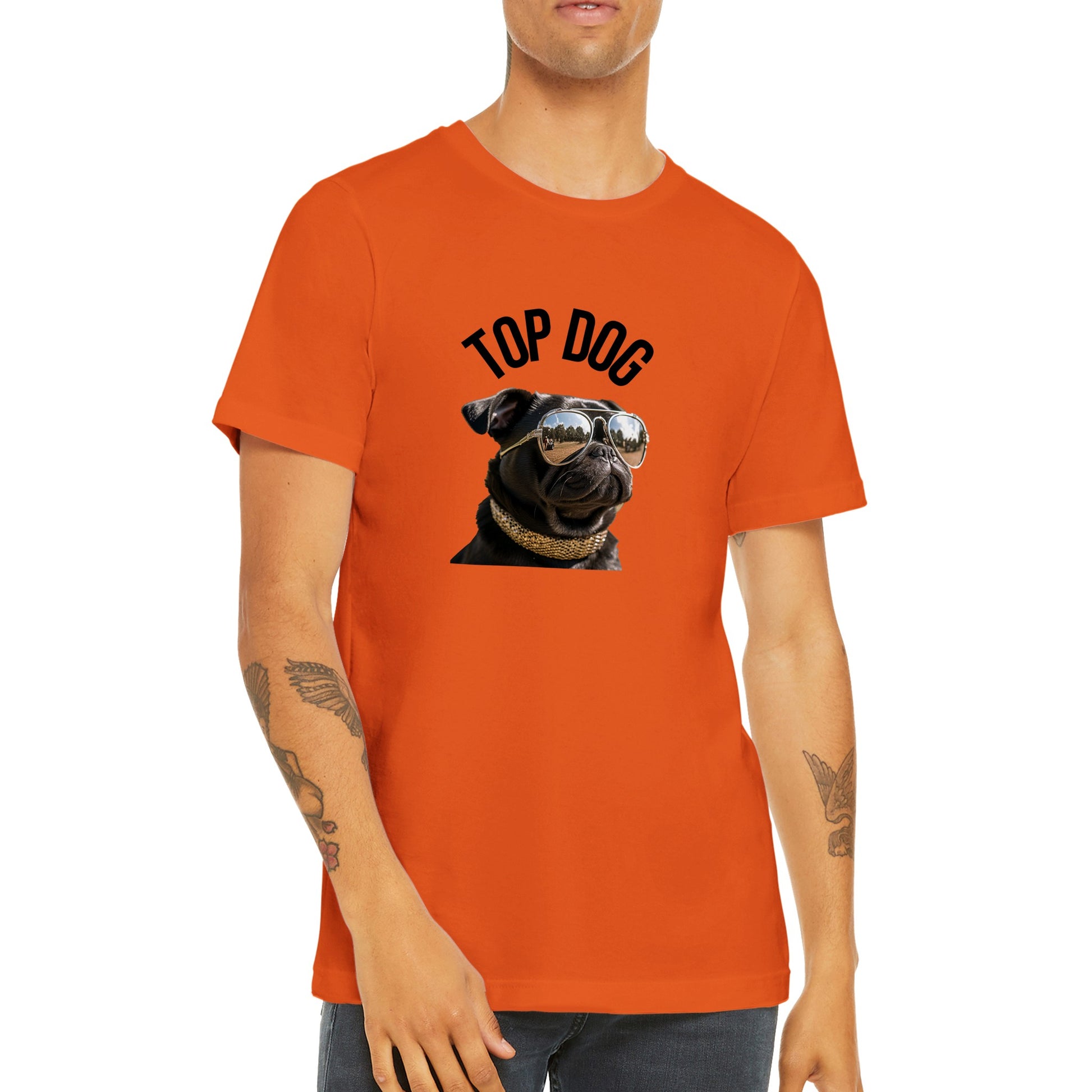 Torso of a young man wearing an orange t-shirt with the image of a black pug wearing reflective aviator sunglasses and a gold collar. The words "Top Dog" are written in an arc above the image.