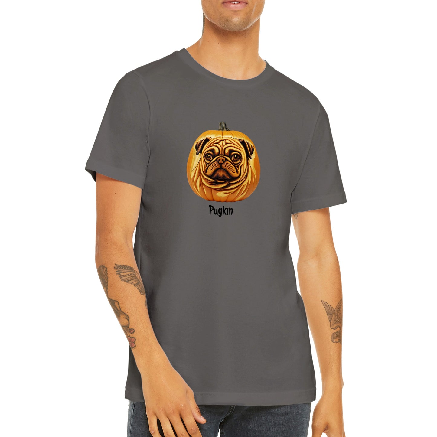 Torso of a young man wearing an asphalt gray t-shirt with a pumpkin that has the face of a pug on it. The word Pugkin is written beneath the image.