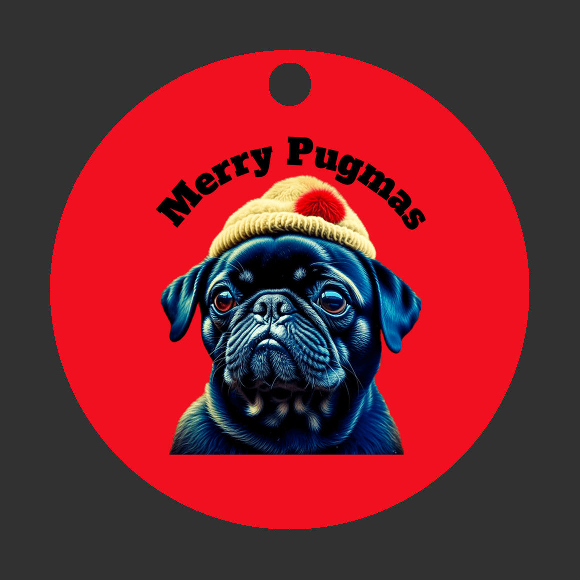 3 inch round ornament on a black background. The ornament is red with the words "Merry Pugmas" arched over the head of a black pug who is wearing a yellow winter hat with a pompom on it.